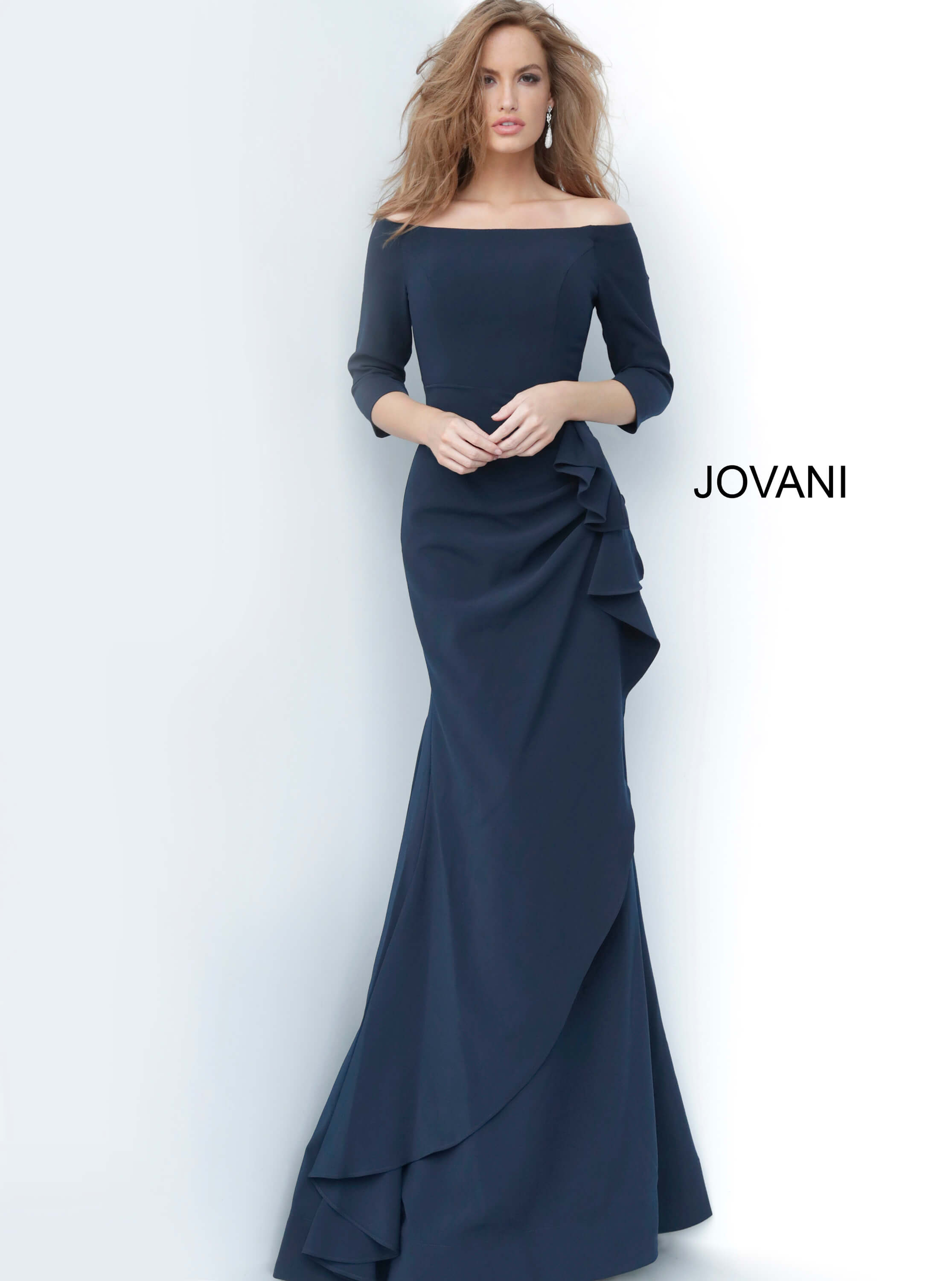 Model in Jovani 00446 navy dress featuring off-the-shoulder neckline and ruffle detail.