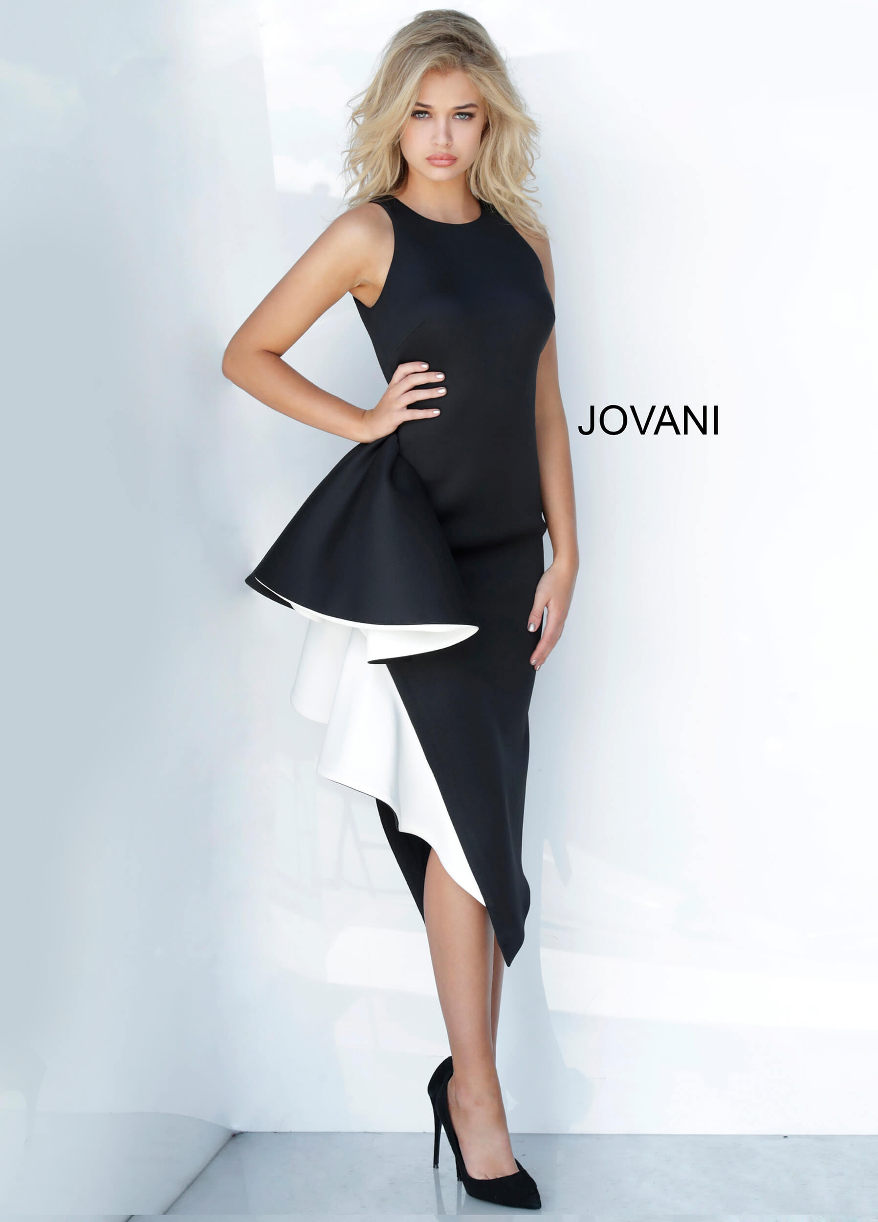 Model in Jovani 00572 black dress with elegant side ruffle.