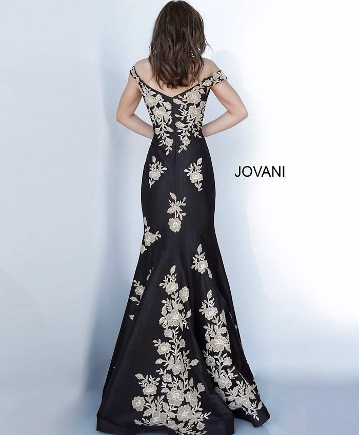 Model wearing Jovani 00635 black gown with gold floral embroidery, back view.