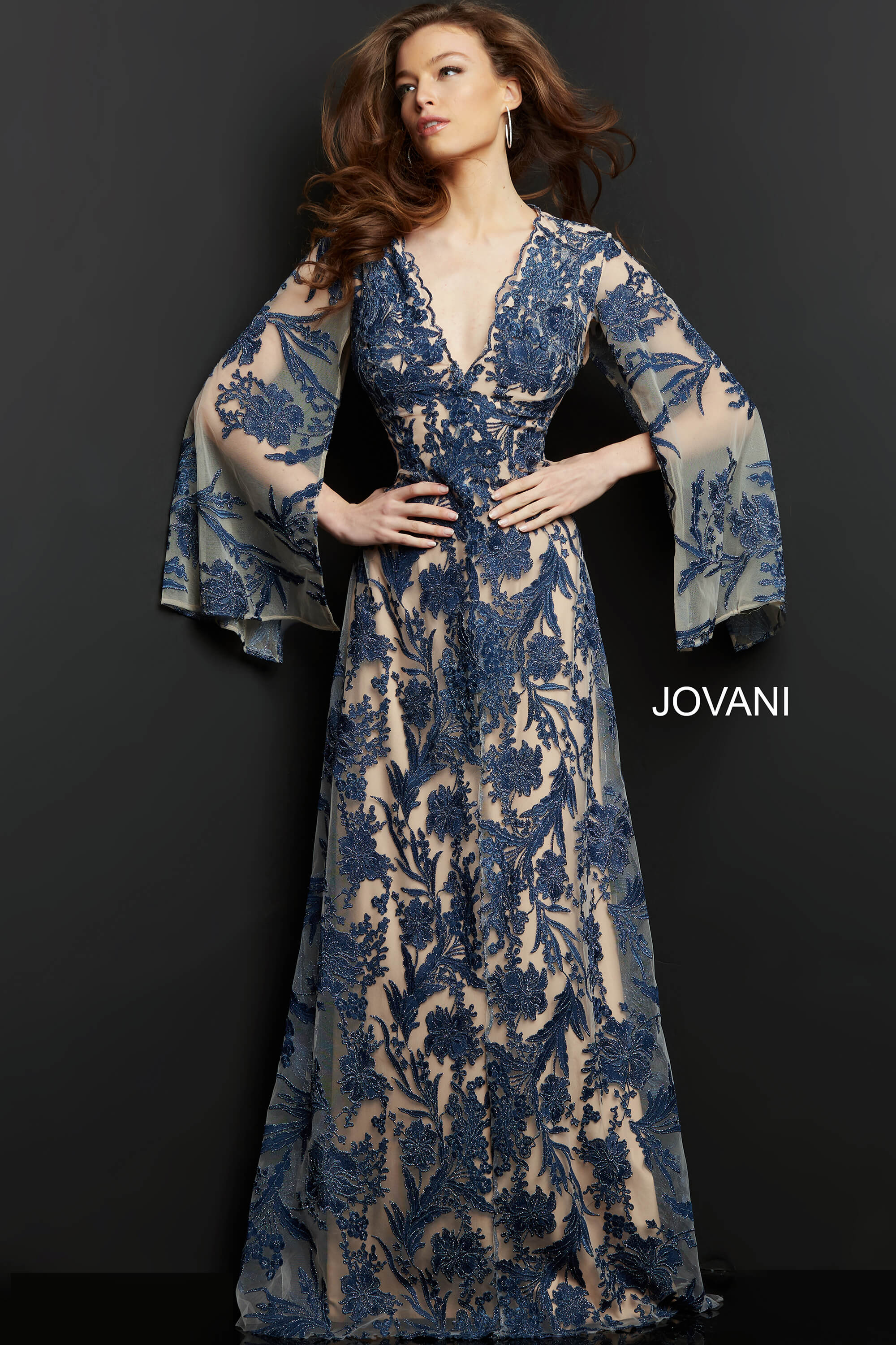 model wearing Jovani 00752 navy A-line gown with floral embroidery and bell sleeves