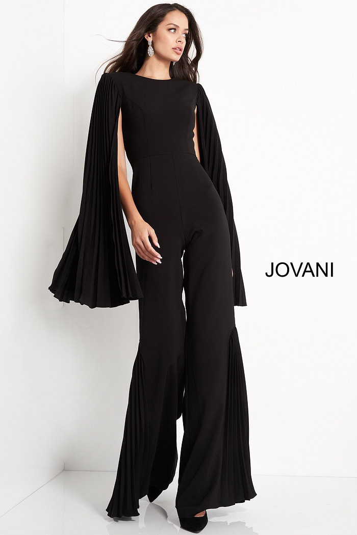 Model wearing Jovani 00756 black jumpsuit with pleated cape sleeves, alternate front view.