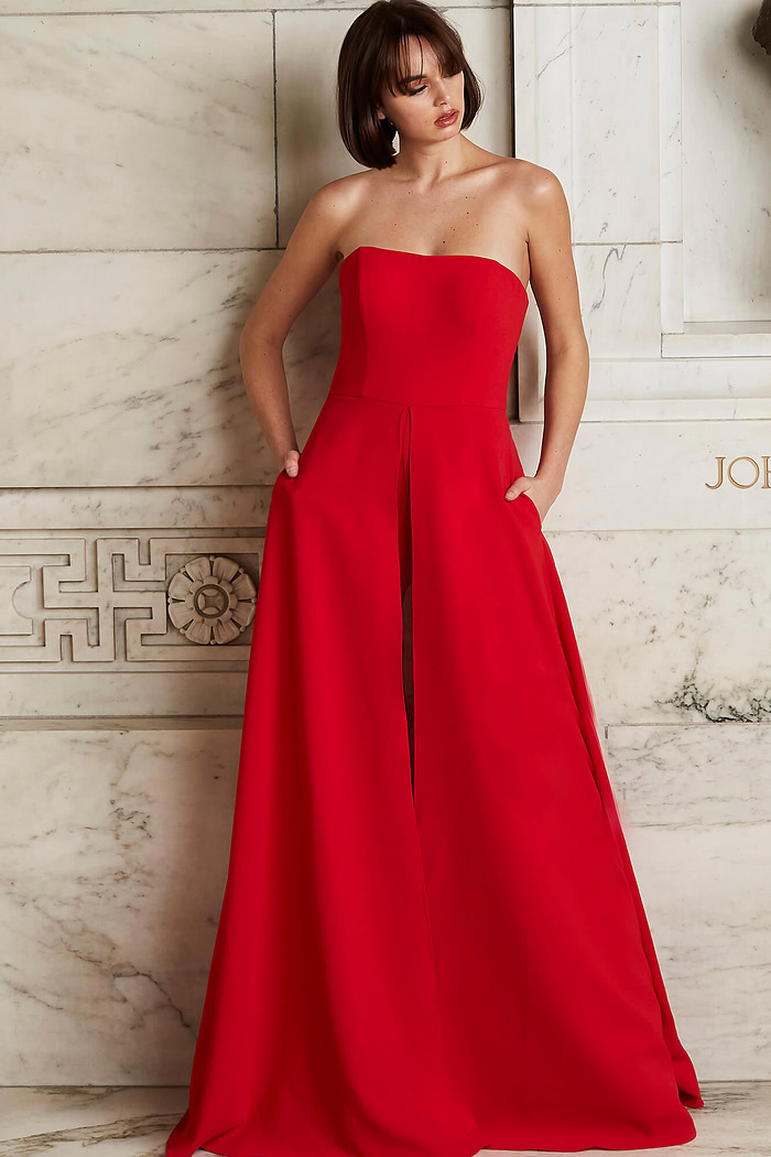 Model wearing Jovani 03529 red jumpsuit, full front view, highlighting the chic strapless fit and wide-leg structure.