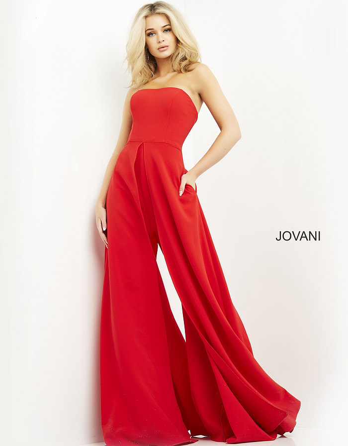 Model showcasing Jovani 03529 red dress with high front slit and strapless design.