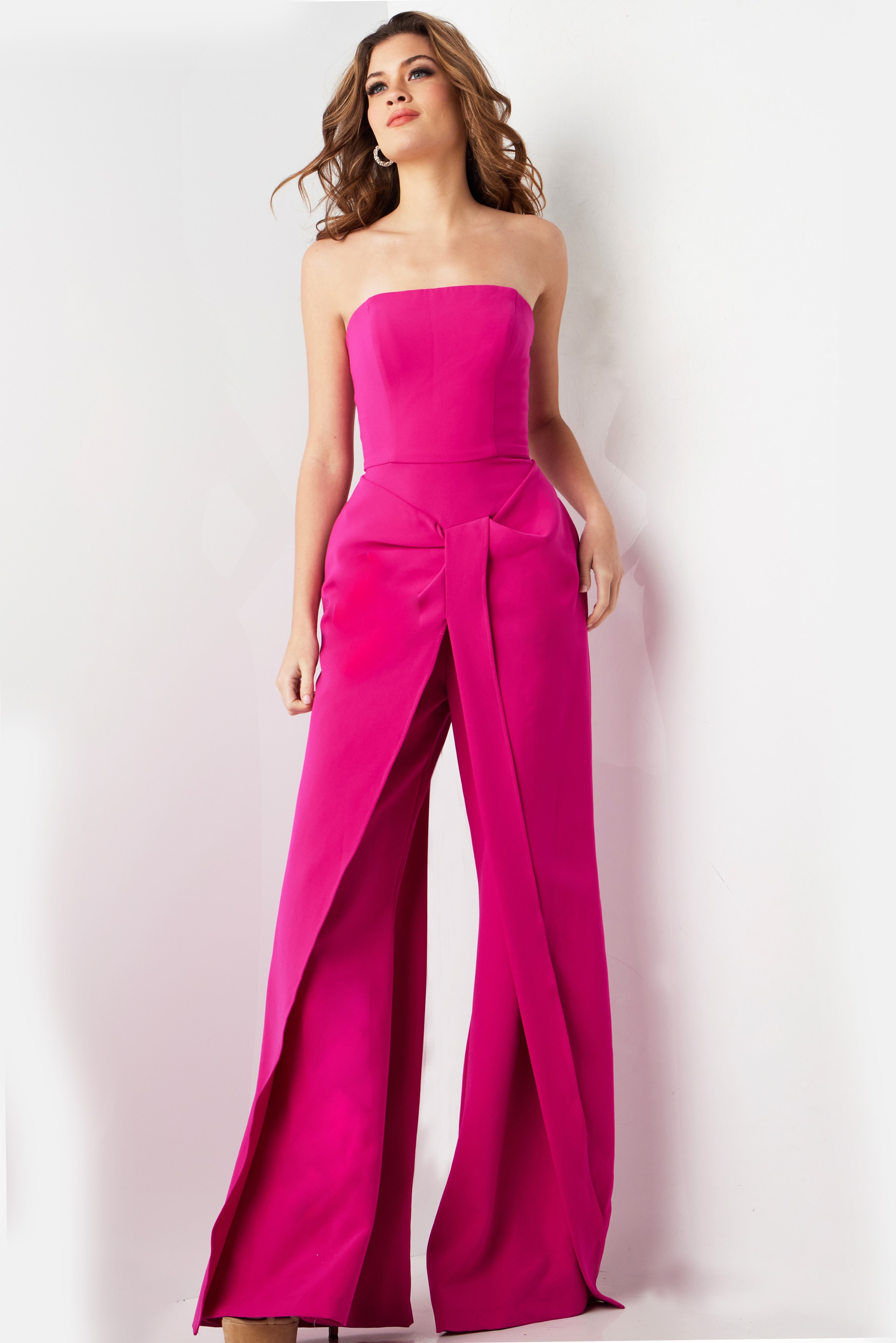Model wearing Jovani 03828 fuchsia strapless jumpsuit with wide-leg pants, front view.