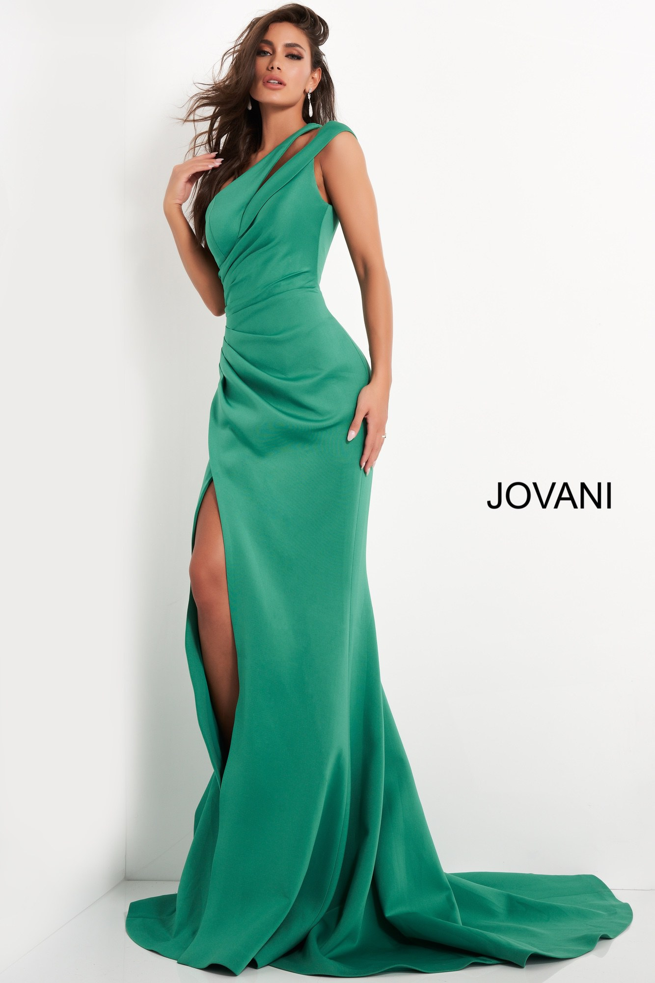 Model showcasing Jovani 04222, a stunning green gown with asymmetric neckline and slit.