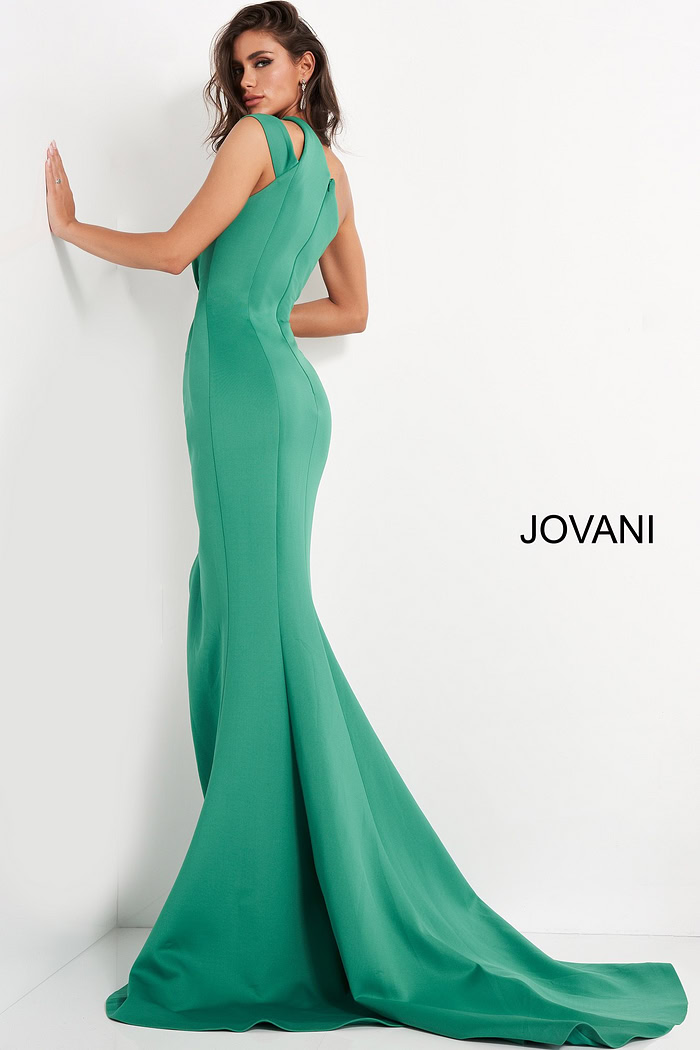 Back pose of model in Jovani 04222, a graceful green dress with flowing train.
