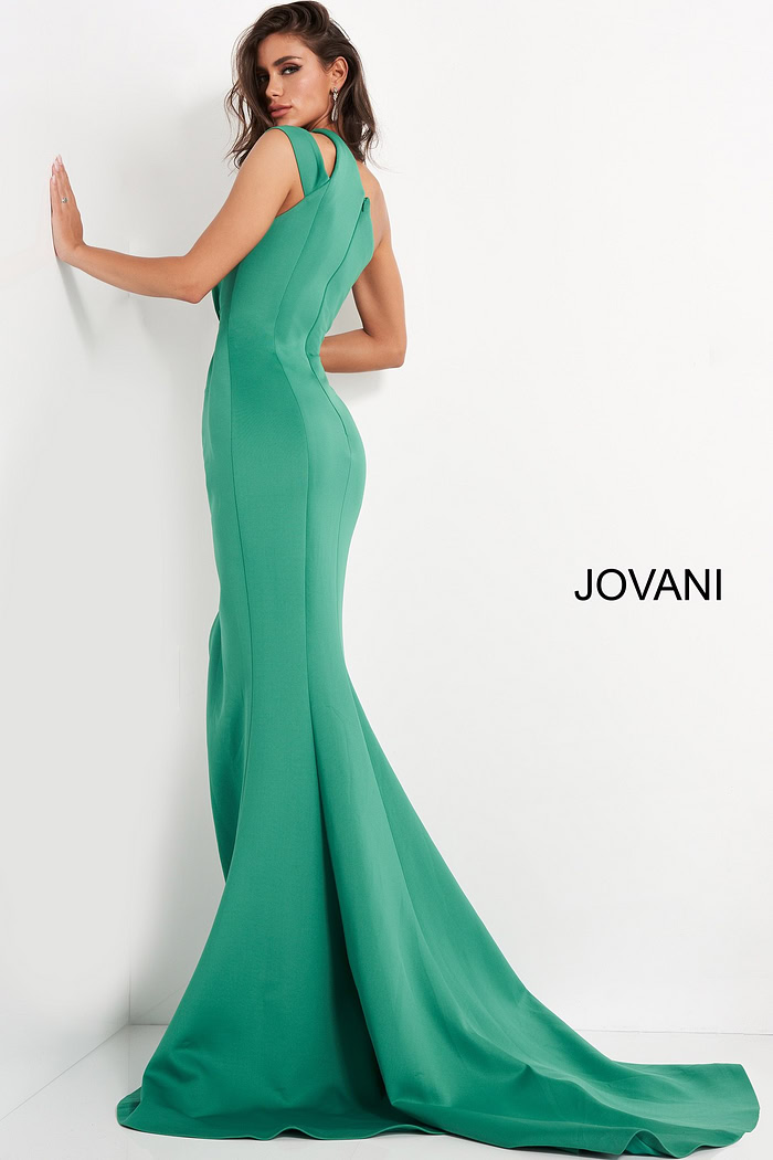 Back view of model wearing Jovani 04222 green gown with flowing hem.