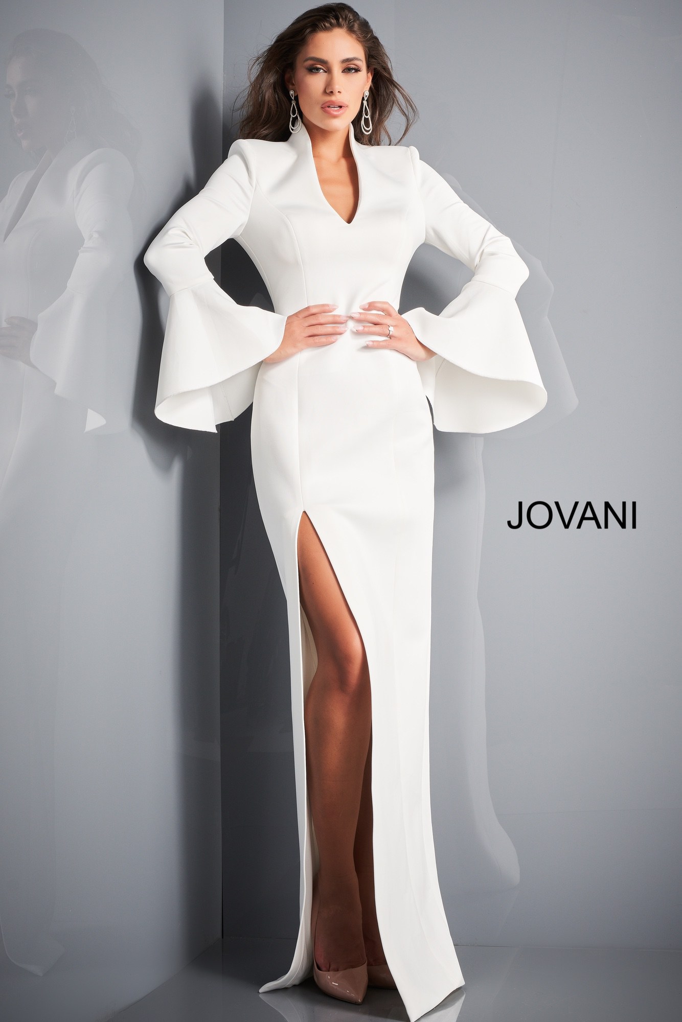 Model in Jovani 04240 white gown featuring high slit and V-neckline.