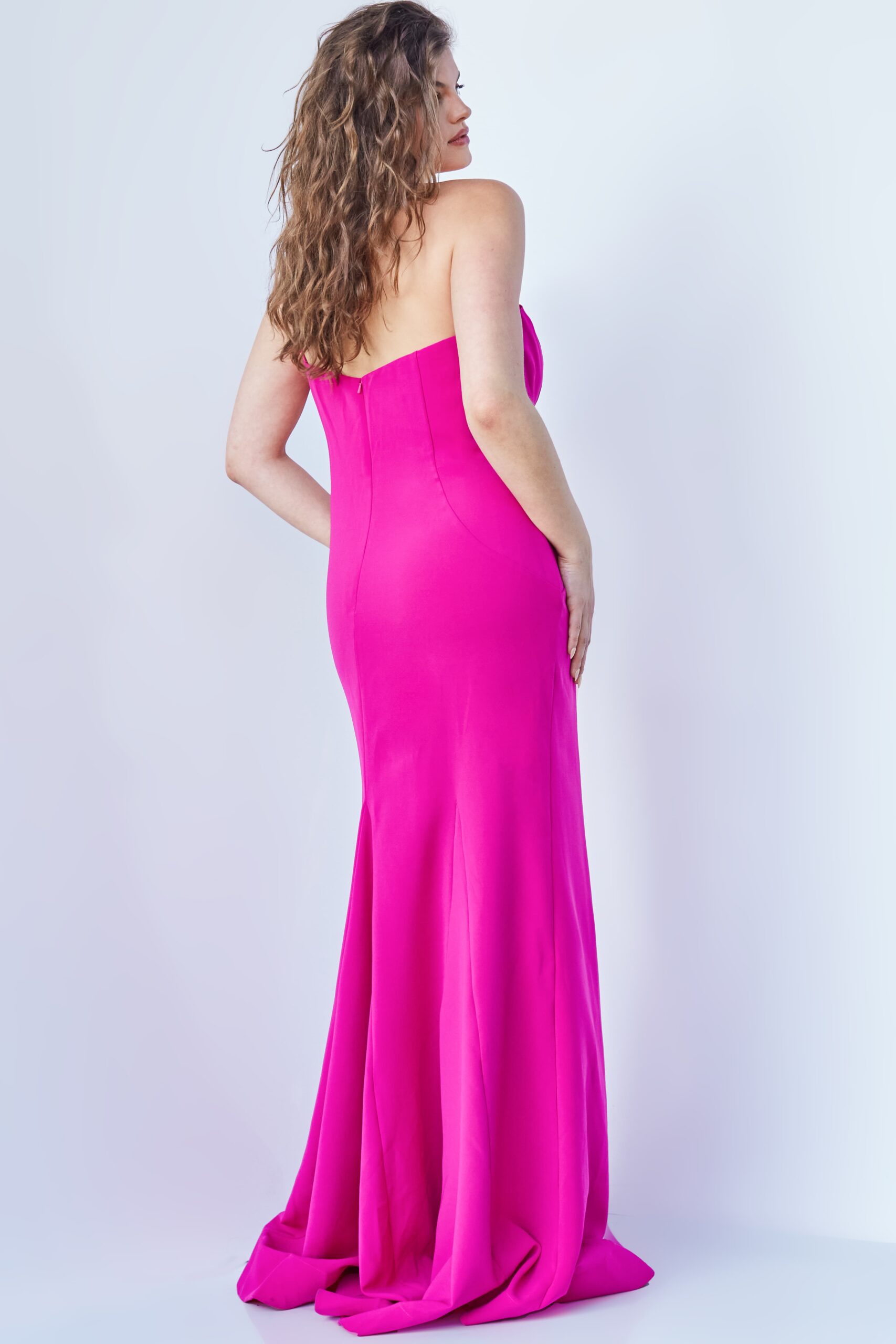 Model displaying Jovani 07306 fuchsia gown, front perspective with neckline and bow detail