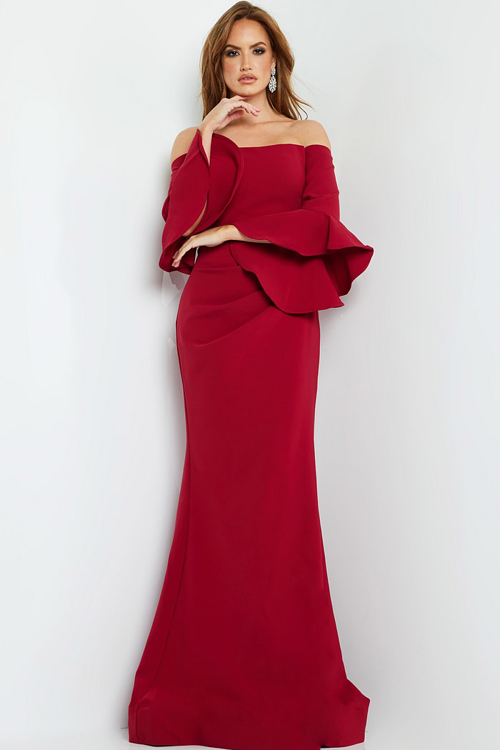 Model in Jovani 07065 cranberry gown, showcasing the off-the-shoulder neckline and elegant body-hugging fit.