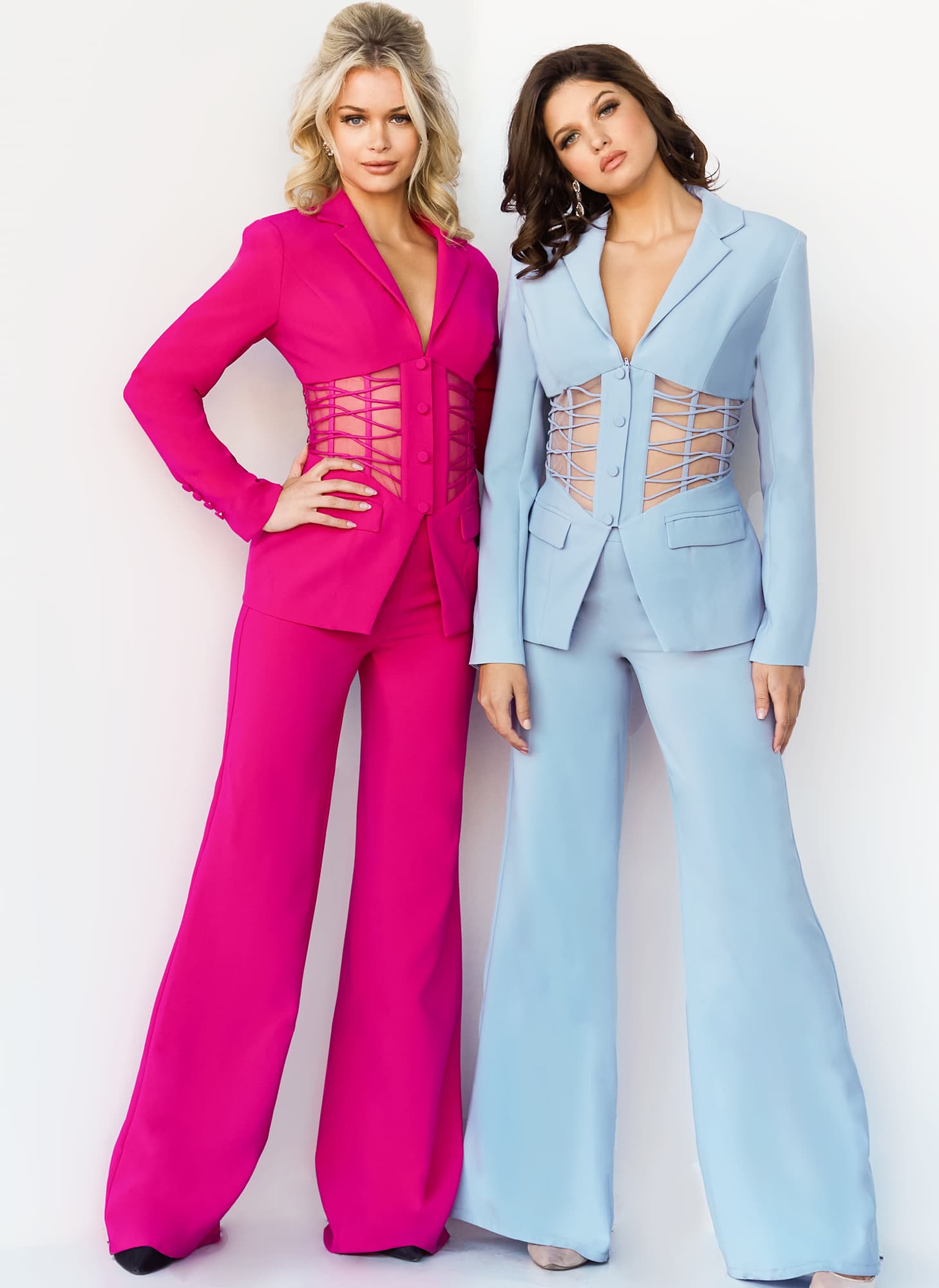Models wearing Jovani 07227 in fuchsia and light blue with lace-up waist detail.