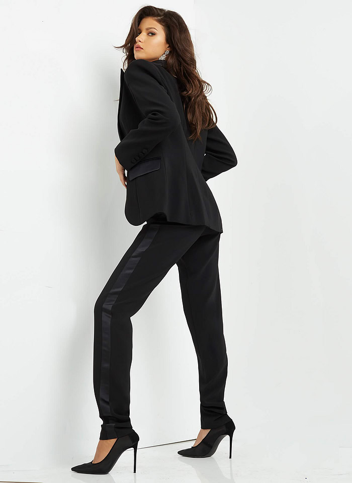 Model wearing Jovani 07293 black jumpsuit, back view.