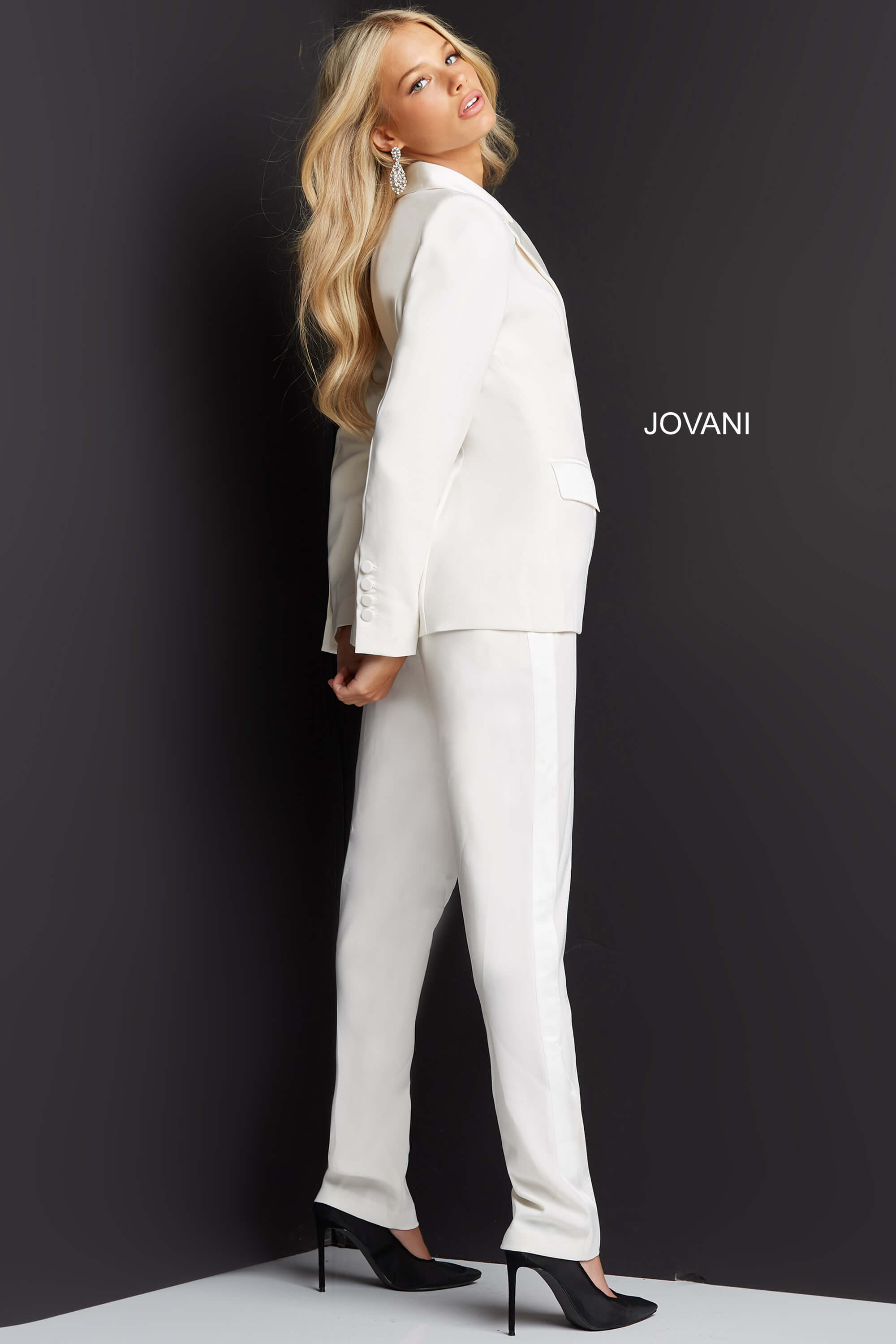 Model wearing Jovani 07293 ivory jumpsuit, back view.
