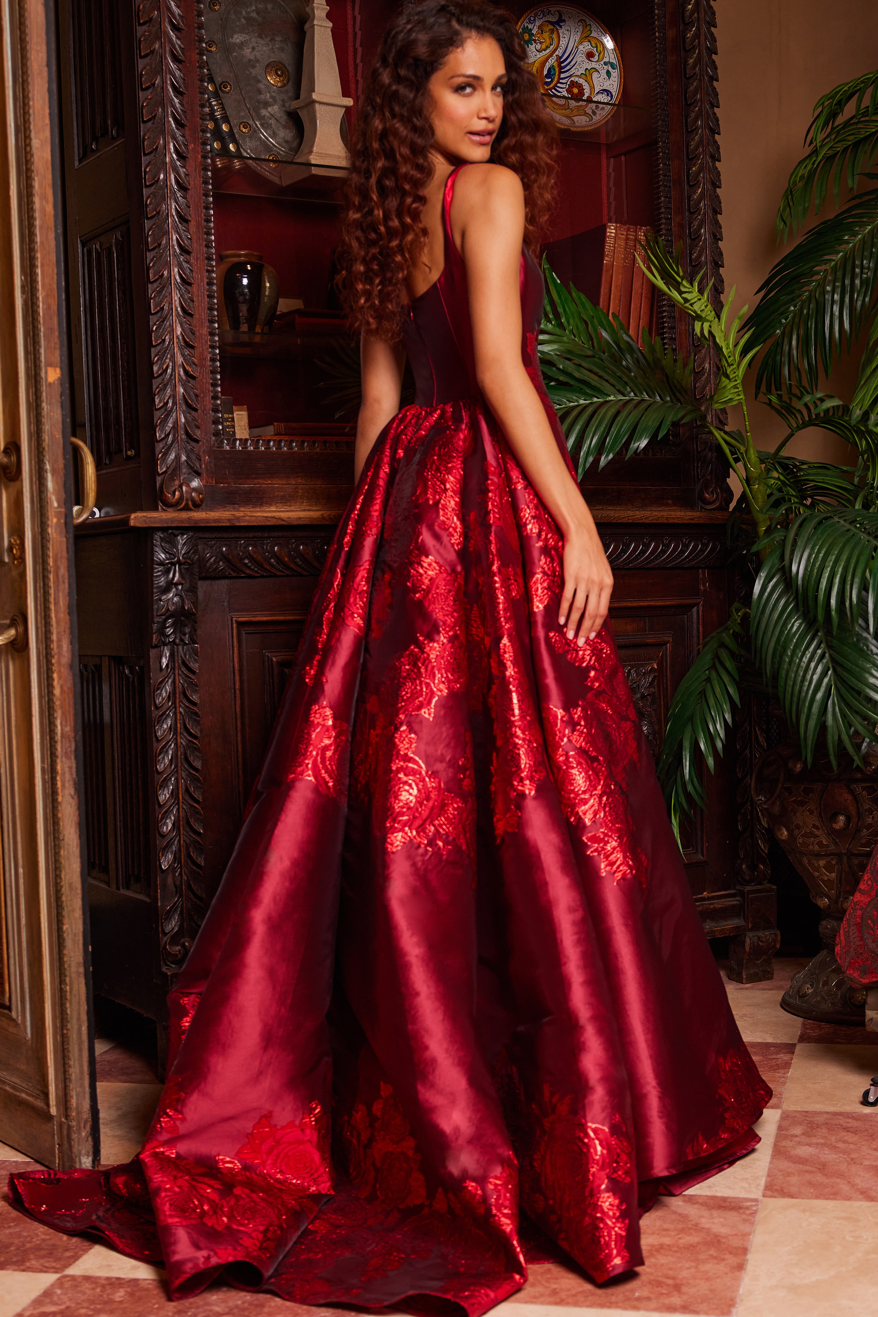 Model in Jovani 07441 purple gown from the back, highlighting the elegant silhouette and embroidery.