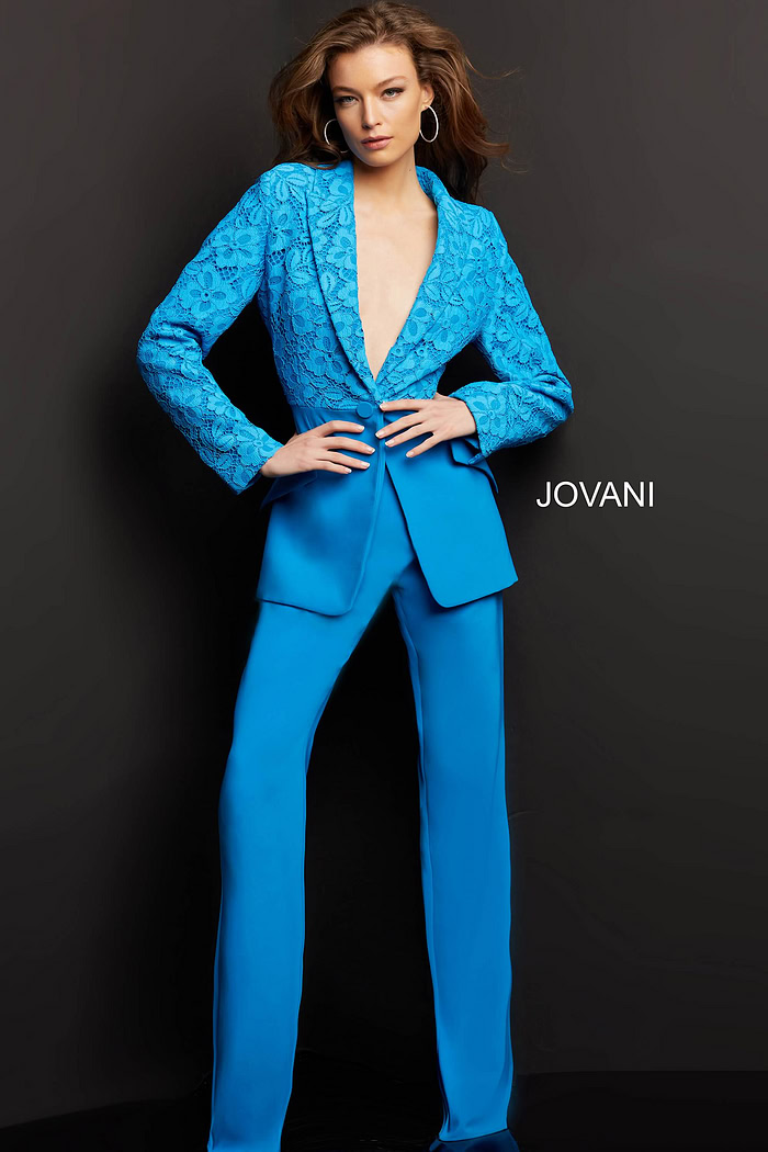 Model wearing Jovani 07551 blue lace blazer with trousers, front view