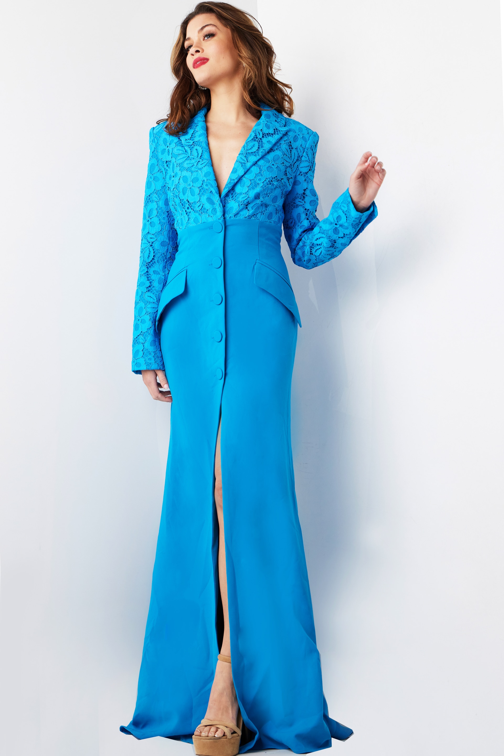 Model wearing Jovani 07552 blue dress with high slit and lace sleeves.