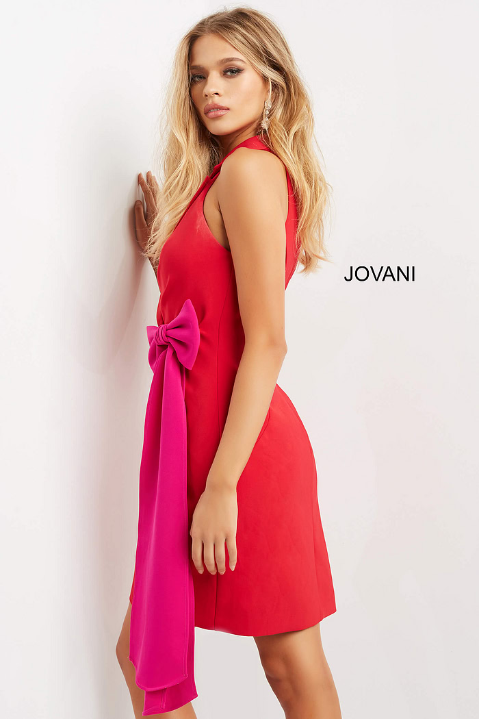 model wearing Jovani 07961 red dress with fuchsia bow detail, angled view