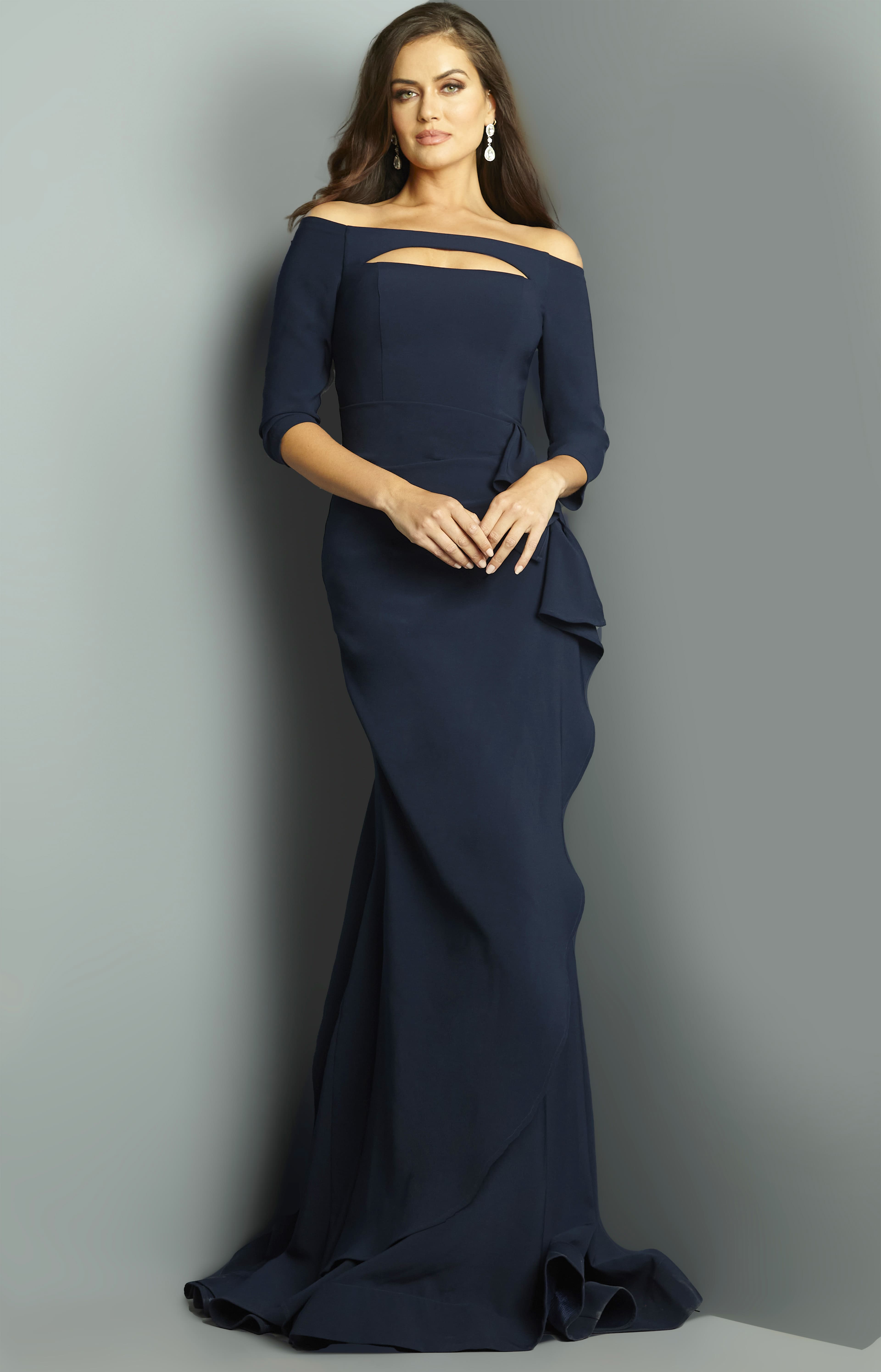 Model showcasing Jovani 09623 navy gown, featuring an off-shoulder neckline with cutout.