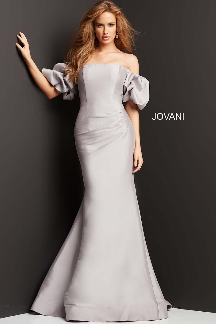 Front view of model in Jovani 08361 taupe mermaid gown with off-shoulder puff sleeves.