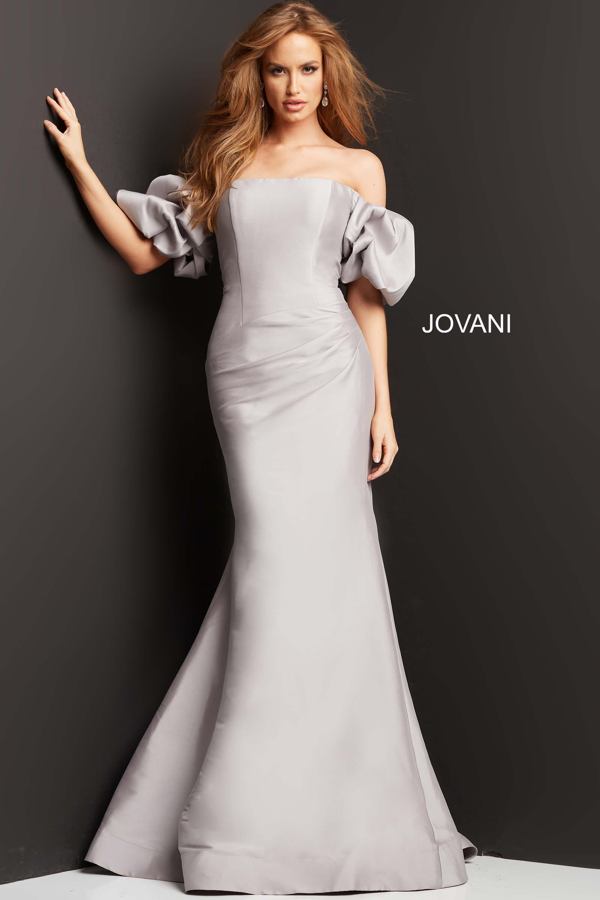 Model wearing Jovani 08361 gown, showing puff sleeves and mermaid silhouette.