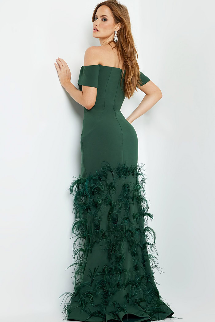 Model displaying the back of Jovani 08384 green mermaid gown highlighting feather details.