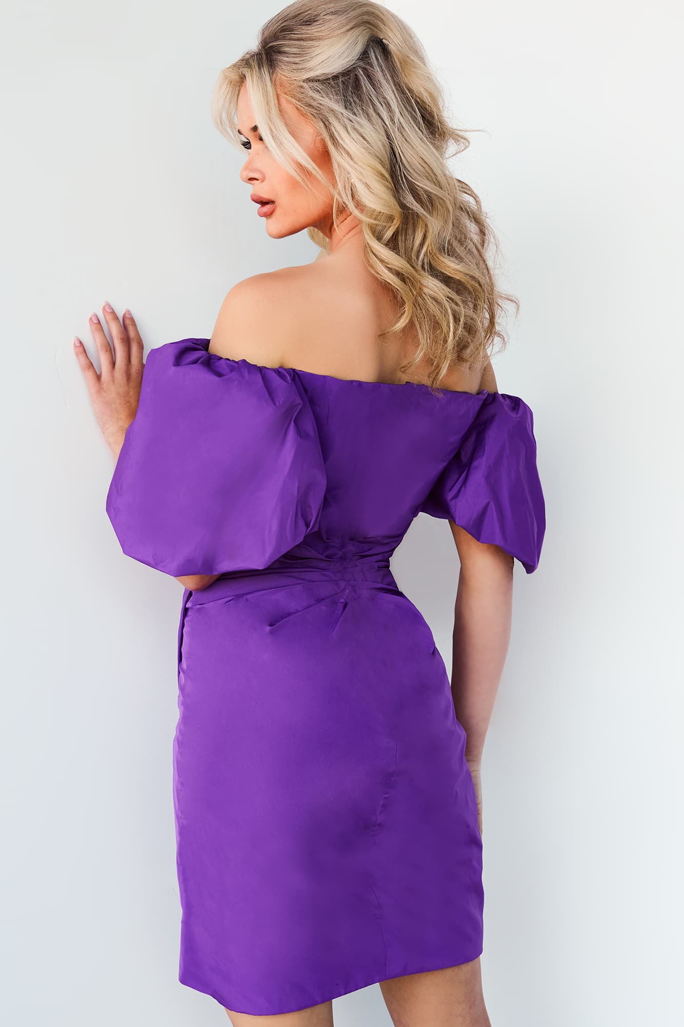 model wearing Jovani 09476 purple dress with off-shoulder neckline and puff sleeves back view