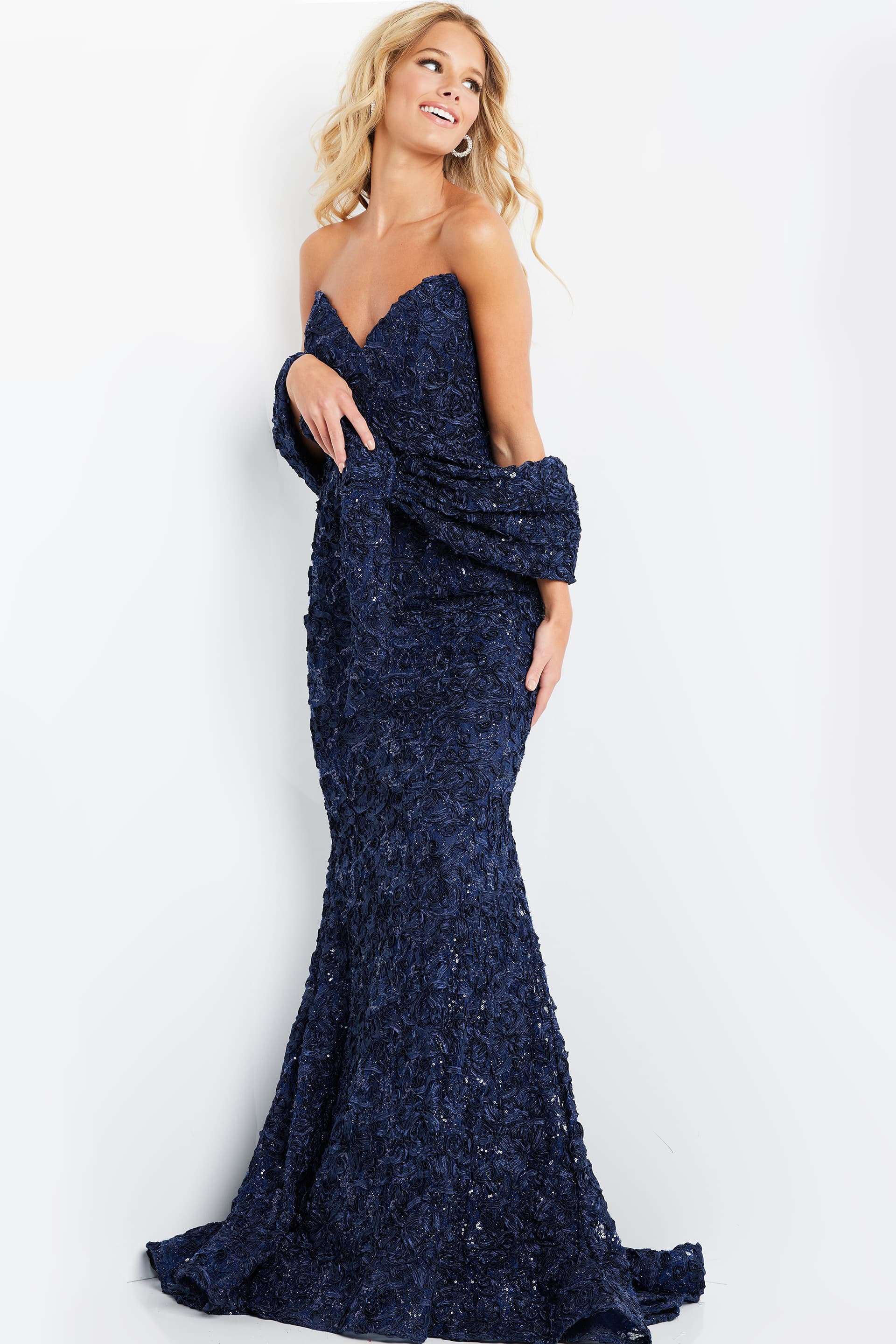 Model wearing Jovani 09768 in navy front view with detailed lace.