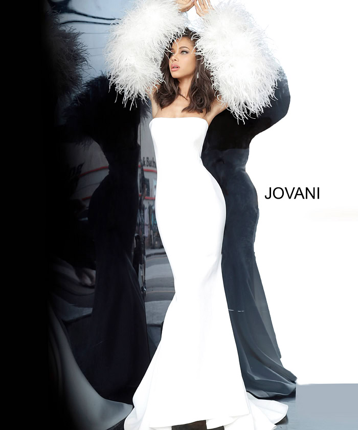 Jovani 1226 white gown with strapless design and feathered sleeves on model.