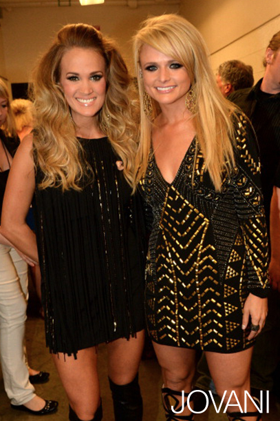 Two models in Jovani 6528 black mini dress with gold details