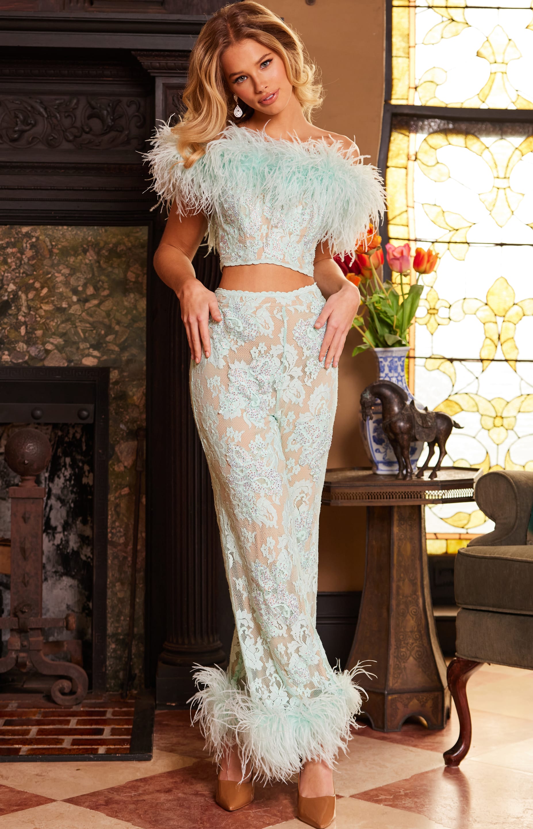 Model wearing Jovani 22350 with a front view showcasing the off-shoulder feathered neckline and lace detail.