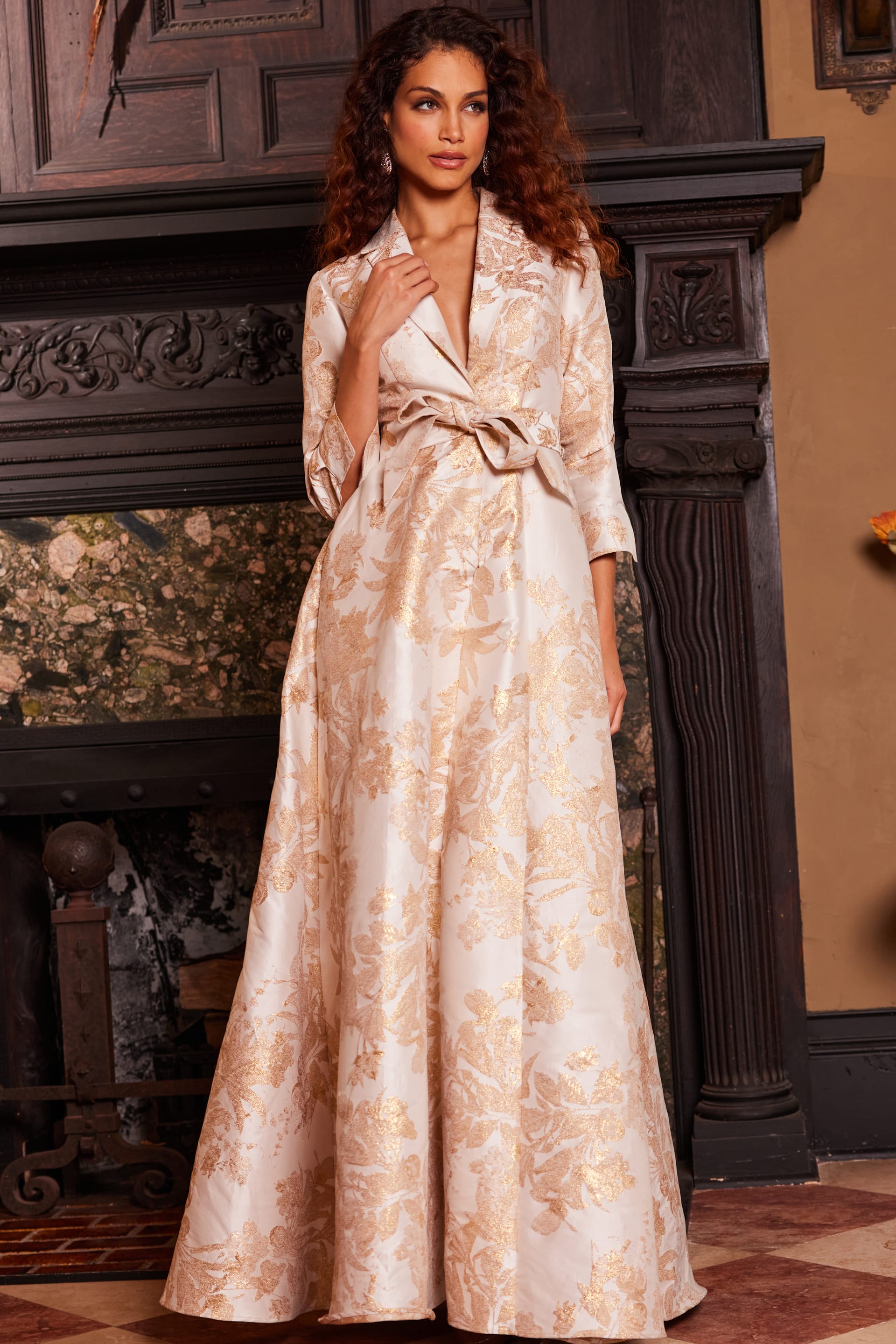 Model wearing Jovani 23178 gold floral brocade dress front view