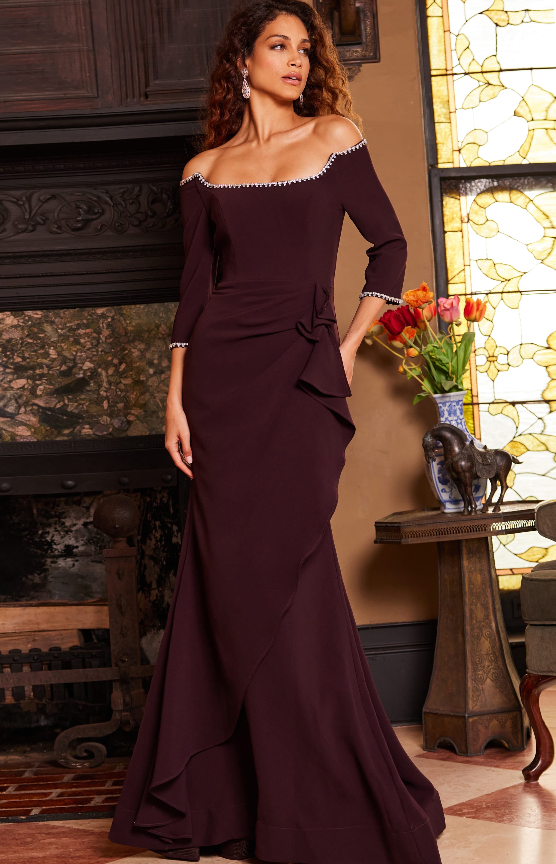 model in Jovani 23190 purple gown showing front detailing