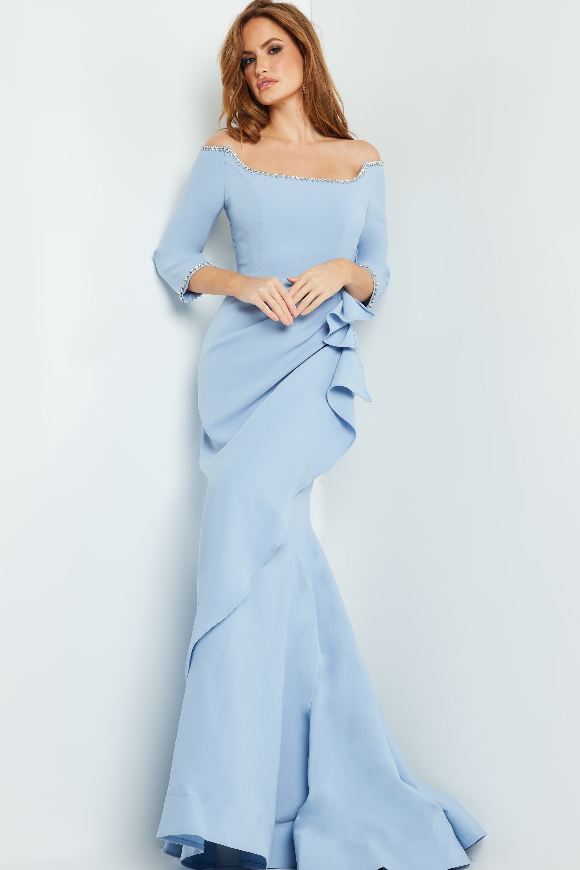 Model in Jovani 23190 light blue dress, front view highlighting mermaid silhouette and embellishments.