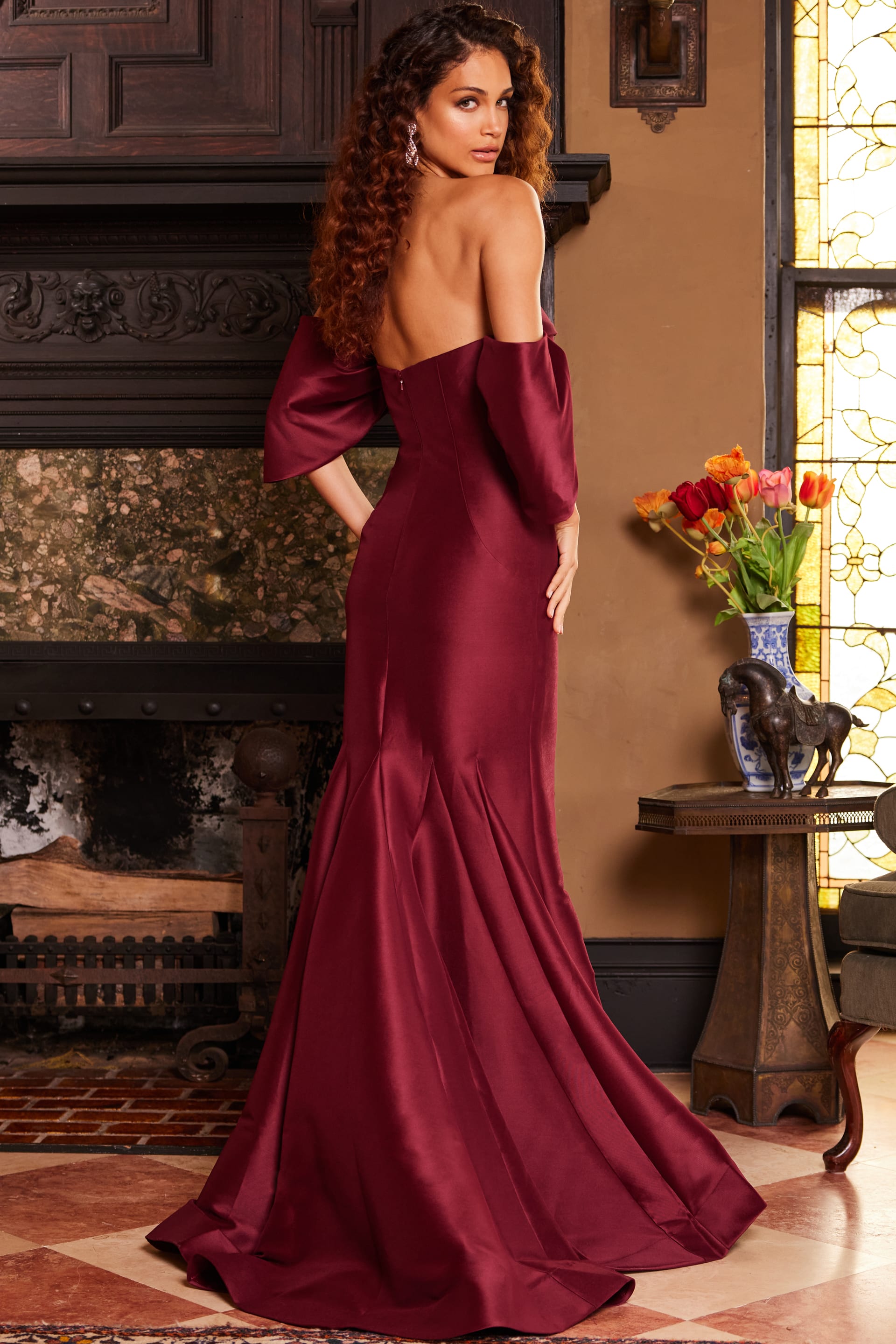 Model wearing Jovani 23398 in burgundy, back view.