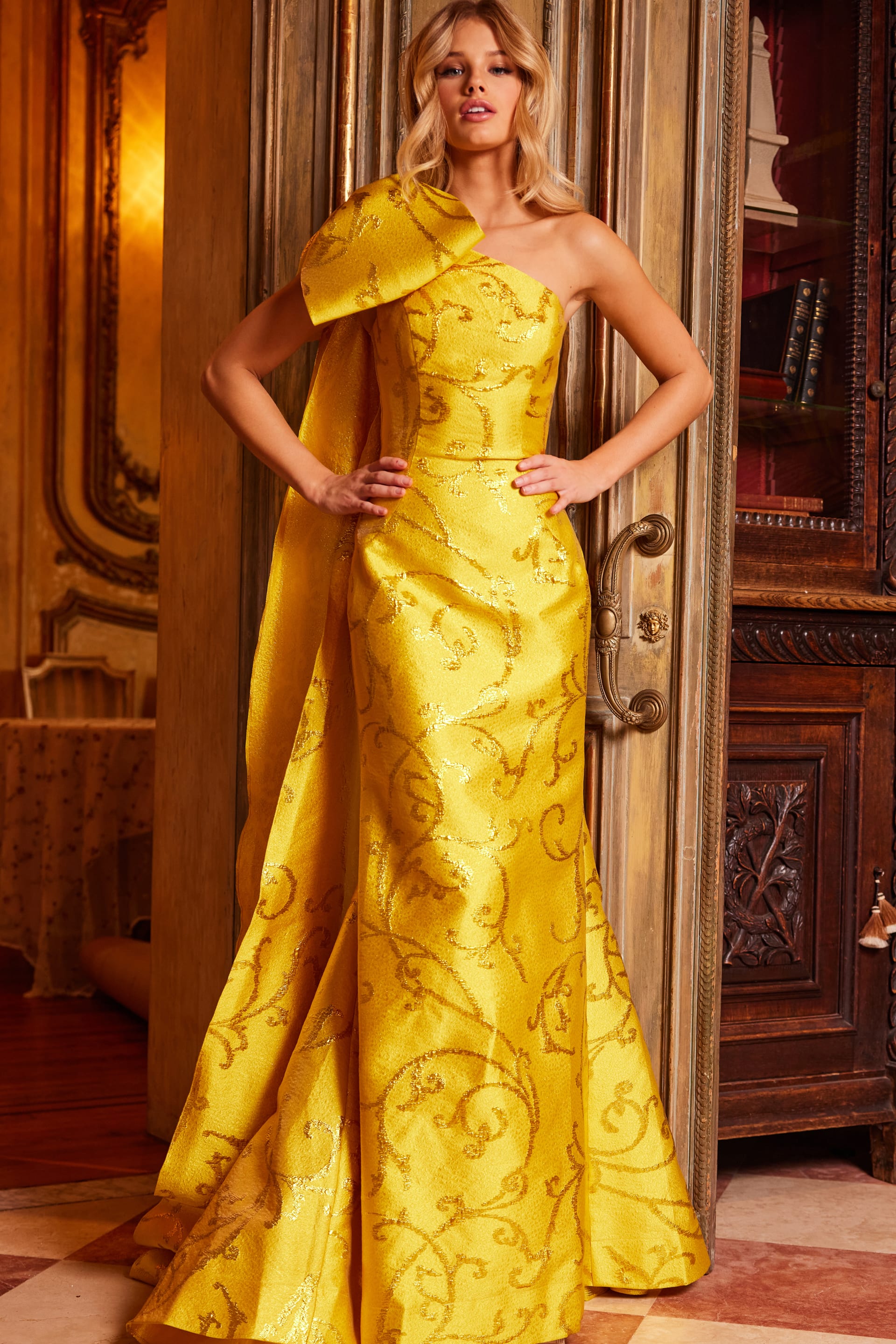 Model wearing Jovani 23742 yellow gown, angled front view highlighting bodice detail.