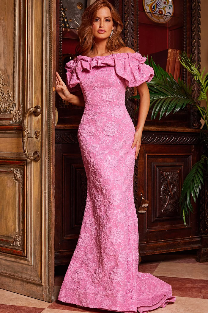 Model wearing Jovani 23847 pink lace dress with ruffled off-the-shoulder neckline