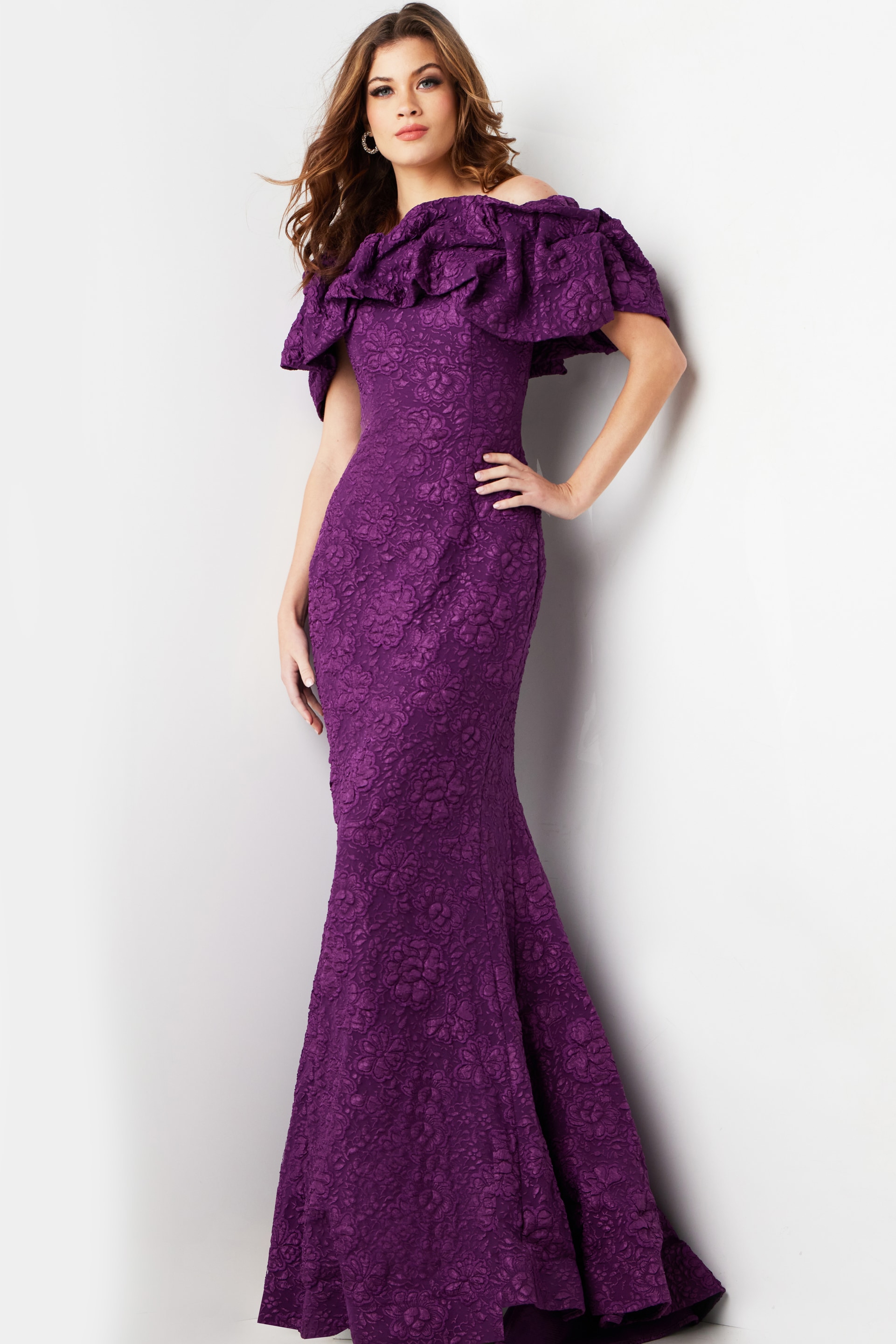Model wearing Jovani 23847 purple lace dress with ruffled off-the-shoulder neckline