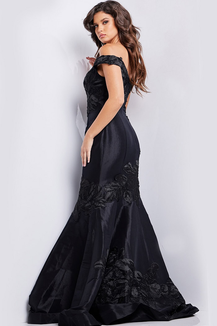 Model wearing Jovani 23928 black dress, back view showcasing mermaid silhouette.