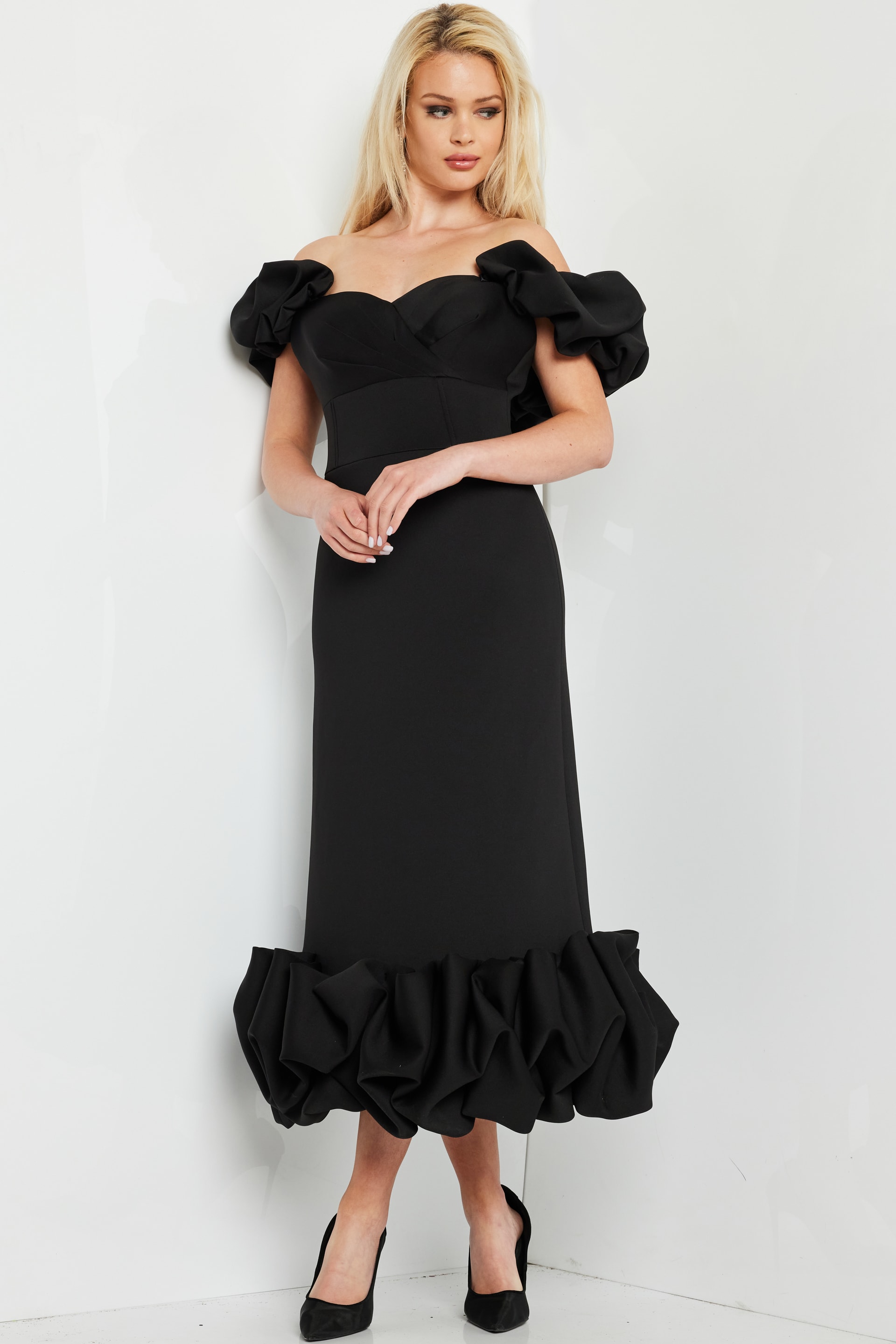 model wearing Jovani 24535 black dress, front view with ruffled details