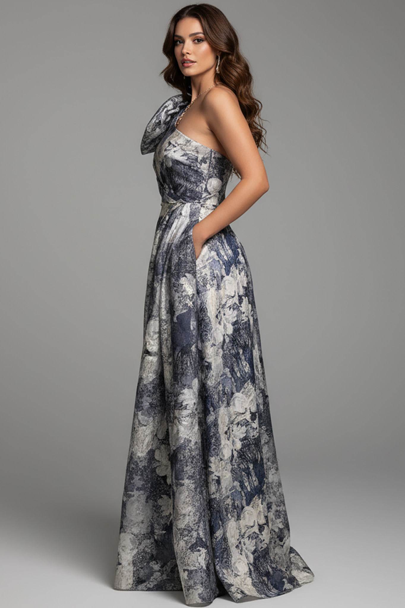 side view of model wearing Jovani 25663 dress showing off the printed pattern and one-shoulder design.