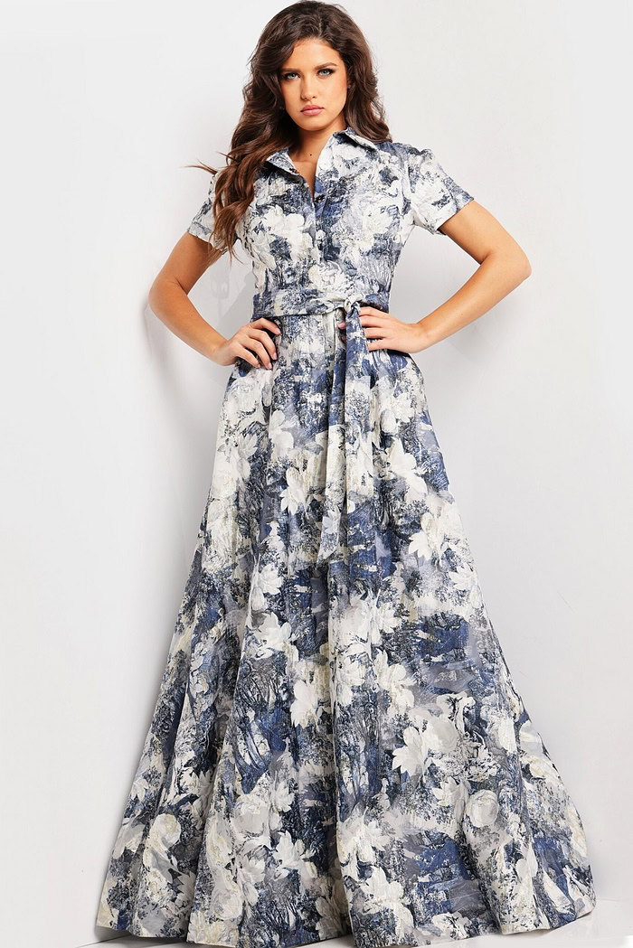 model showcasing Jovani 25664 full-length A-line gown with intricate print and belt