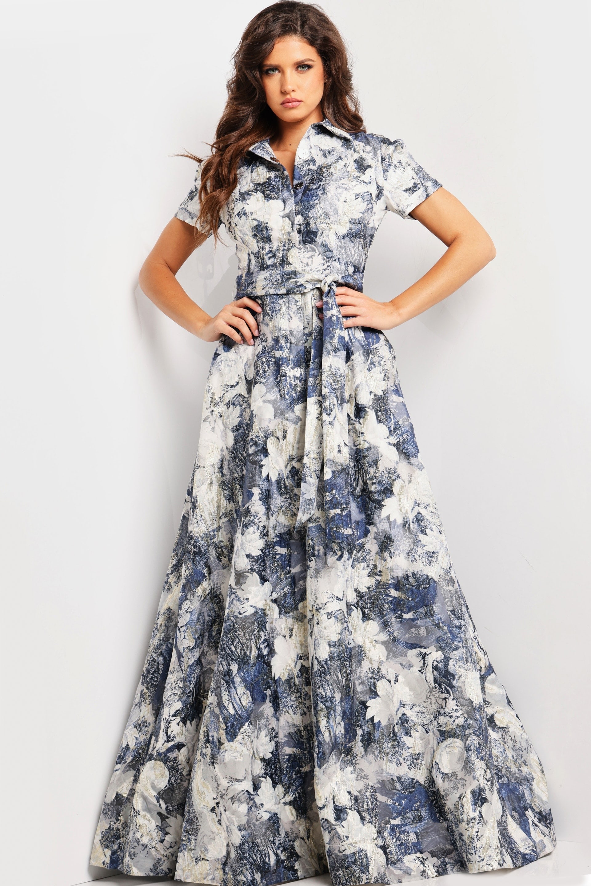 model showcasing Jovani 25664 full-length A-line gown with intricate print and belt