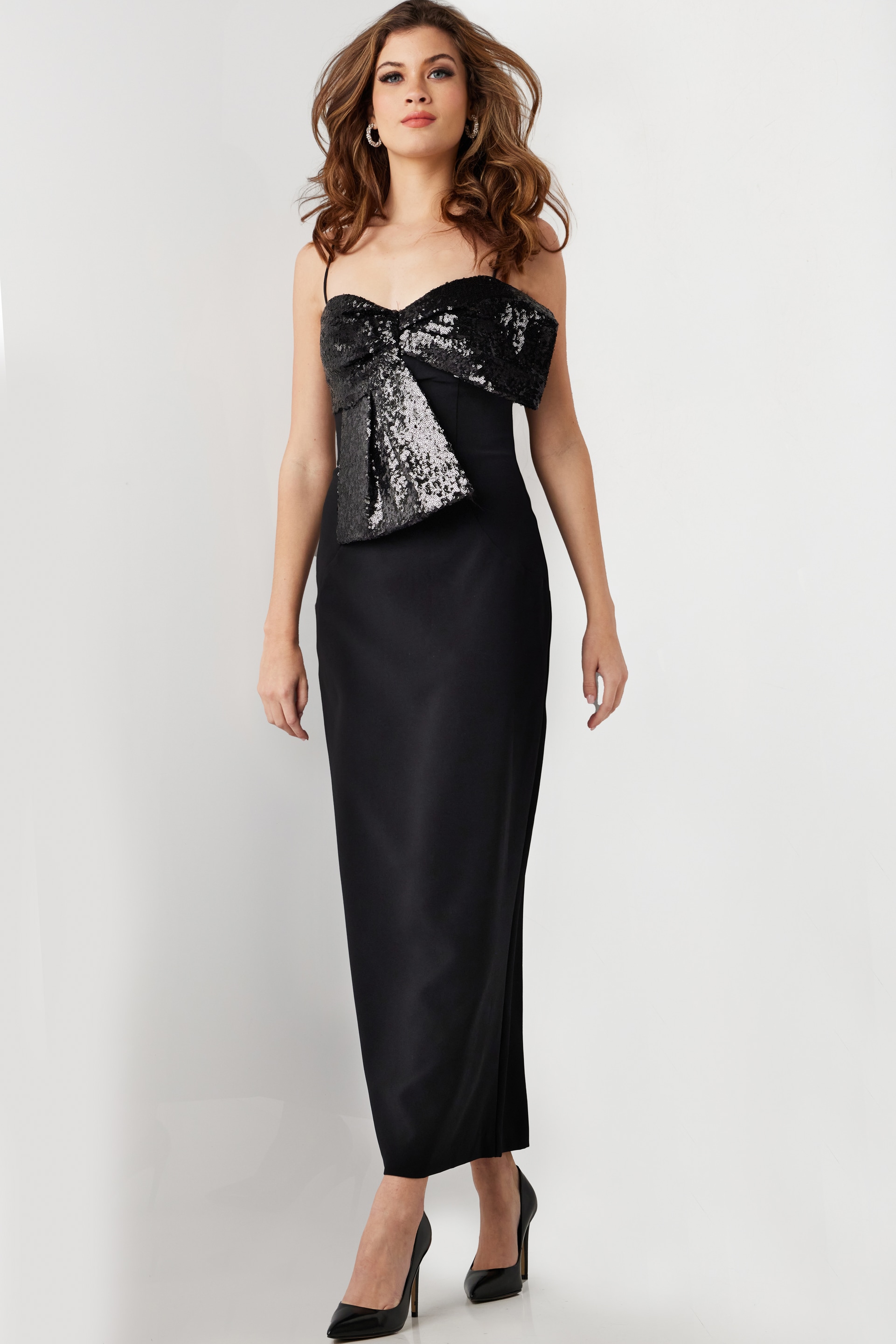 Front view of model wearing Jovani 25745 midi black dress with sequin bow.