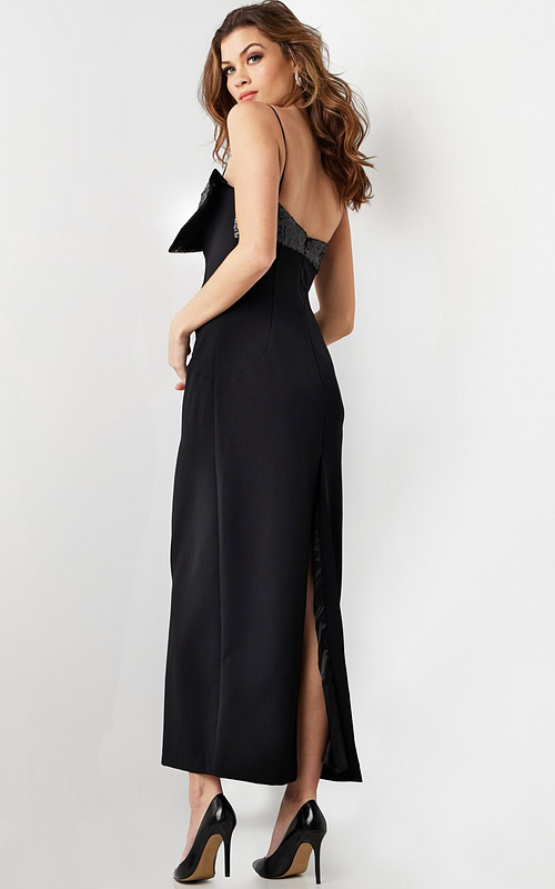 Back view of model wearing Jovani 25745 elegant black dress with a back slit.