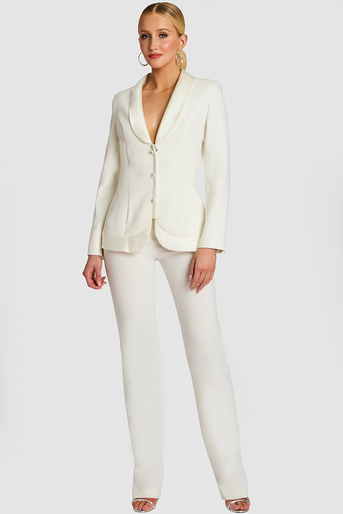 Model wearing an off-white tailored pantsuit with shawl lapel and button closure, front view.