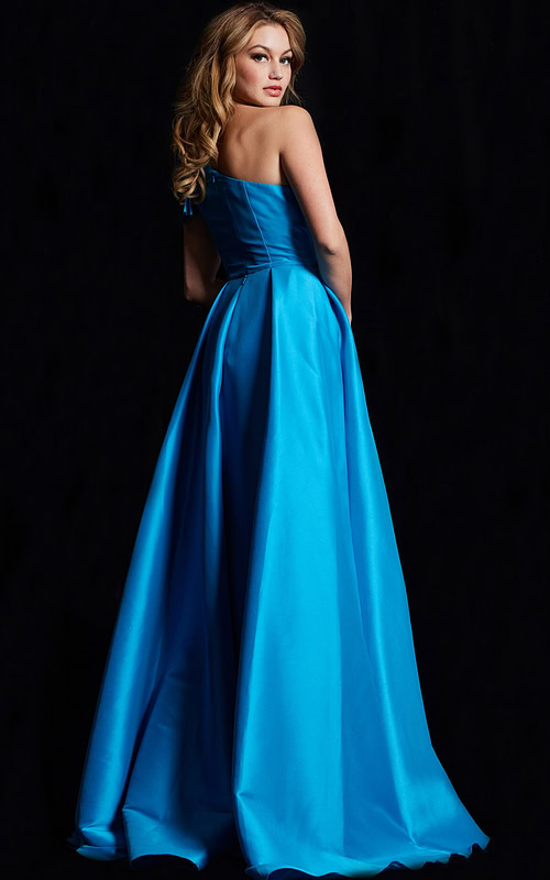 Back view of model in Jovani 26146, a blue gown with an elegant flow.