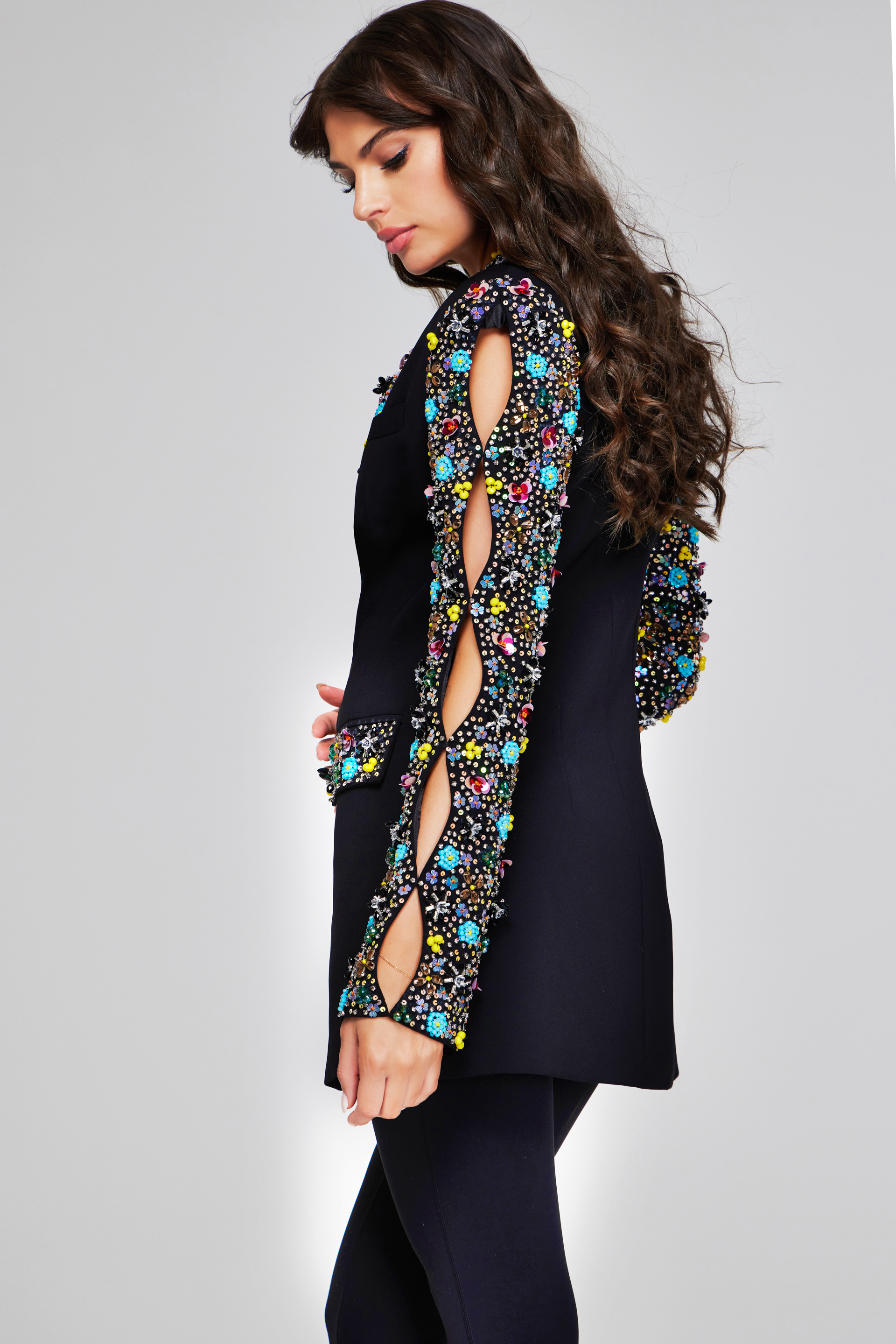 model wearing Jovani 26304 black dress, side view with embellishments