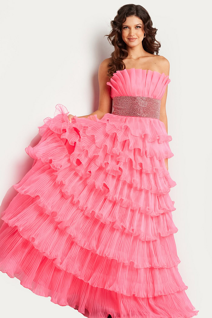 Model wearing Jovani 26314 pink gown showcasing tiered ruffles.