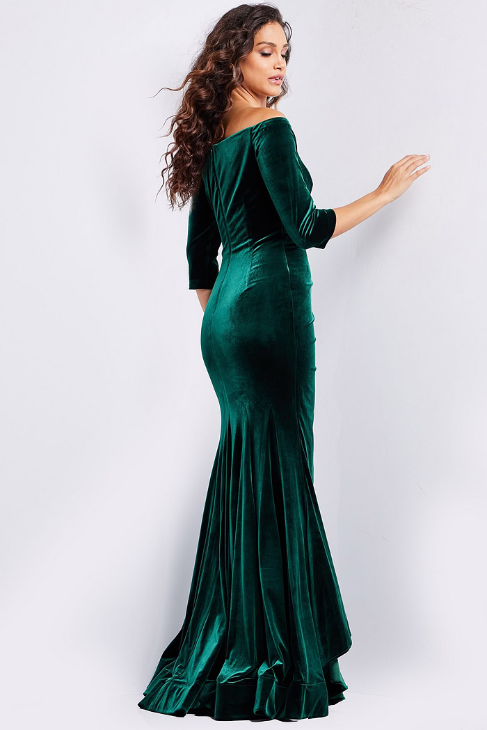 back view of model wearing 36458 green velvet dress with off-the-shoulder detail