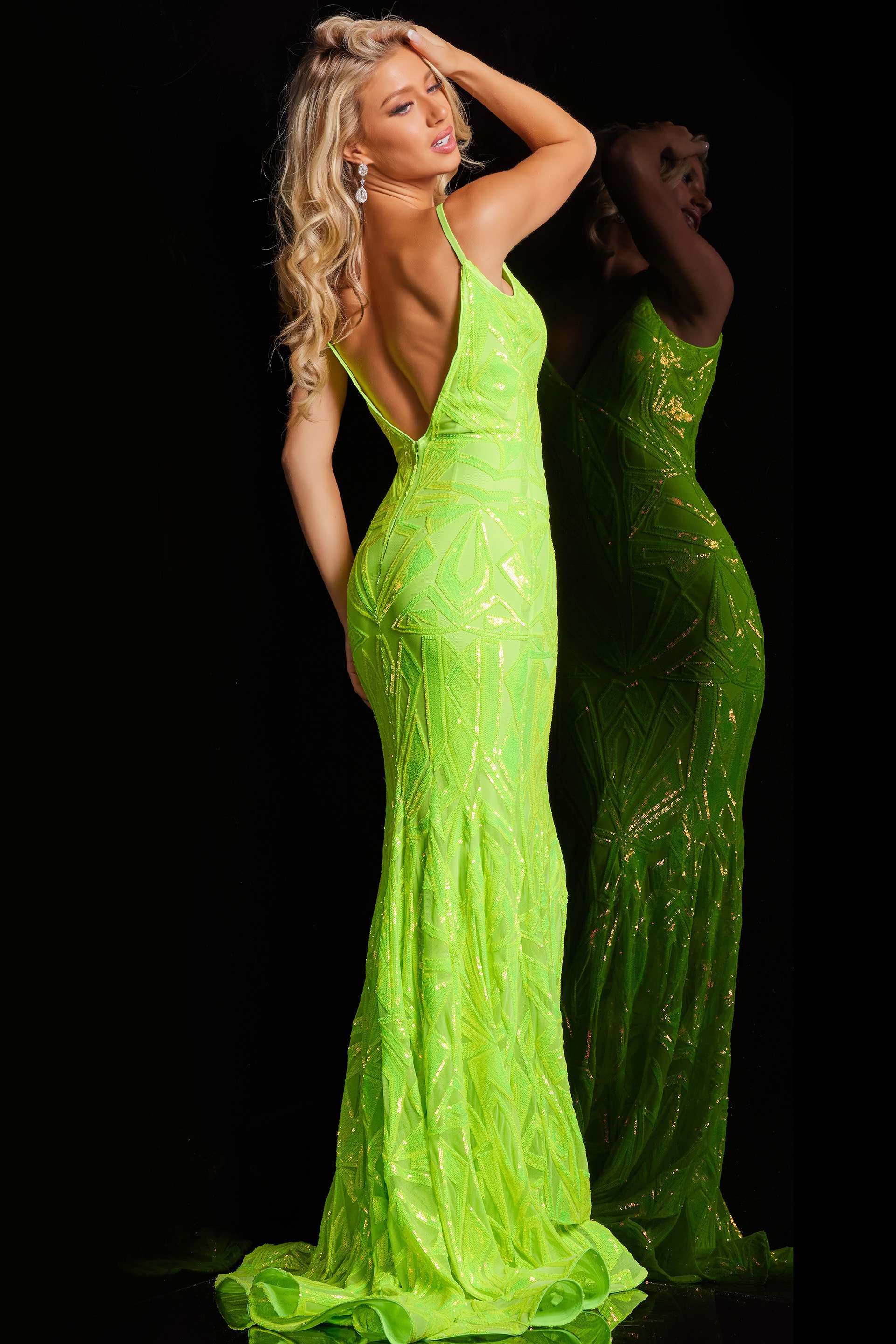 Back view of model in Jovani 36656 green mermaid gown with sequined design.